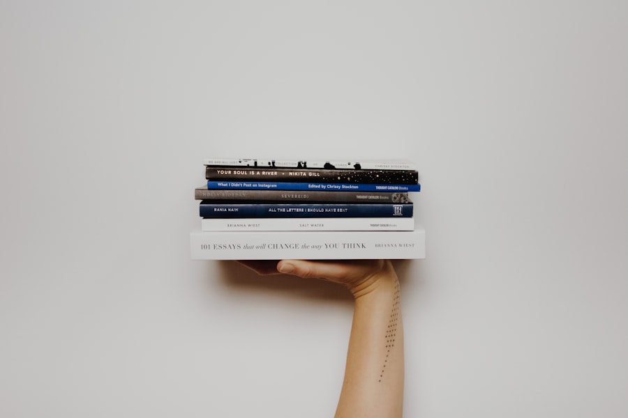 Hand holding a stack of books